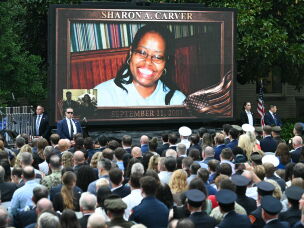 An image of Sharon Carver, who died at the Pentagon on 9/11, is displayed on a screen during the 25th anniversary commemoration of the Sept. 11, 2001, attacks at the Pentagon on Friday.