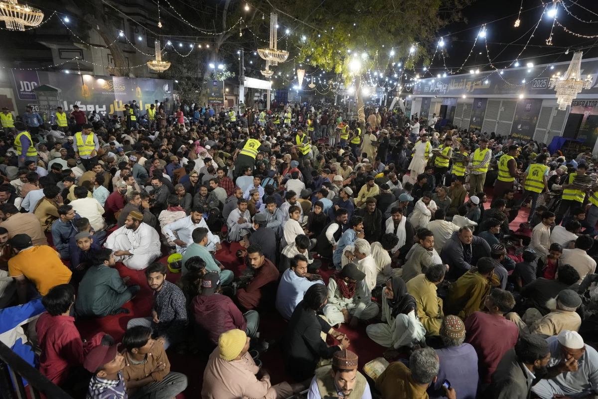 Volunteers distribute food among families for the pre-dawn sehri meal before starting their fast during the Muslim holy month of Ramadan, at a free meal distribution center run by a charity group in Karachi, March 2.