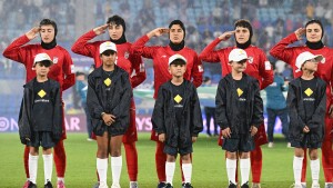 FILE - Iran players react during their national anthem ahead of the Women's Asian Cup soccer match between Iran and the Philippines in Robina, Australia, Sunday, March 8, 2026