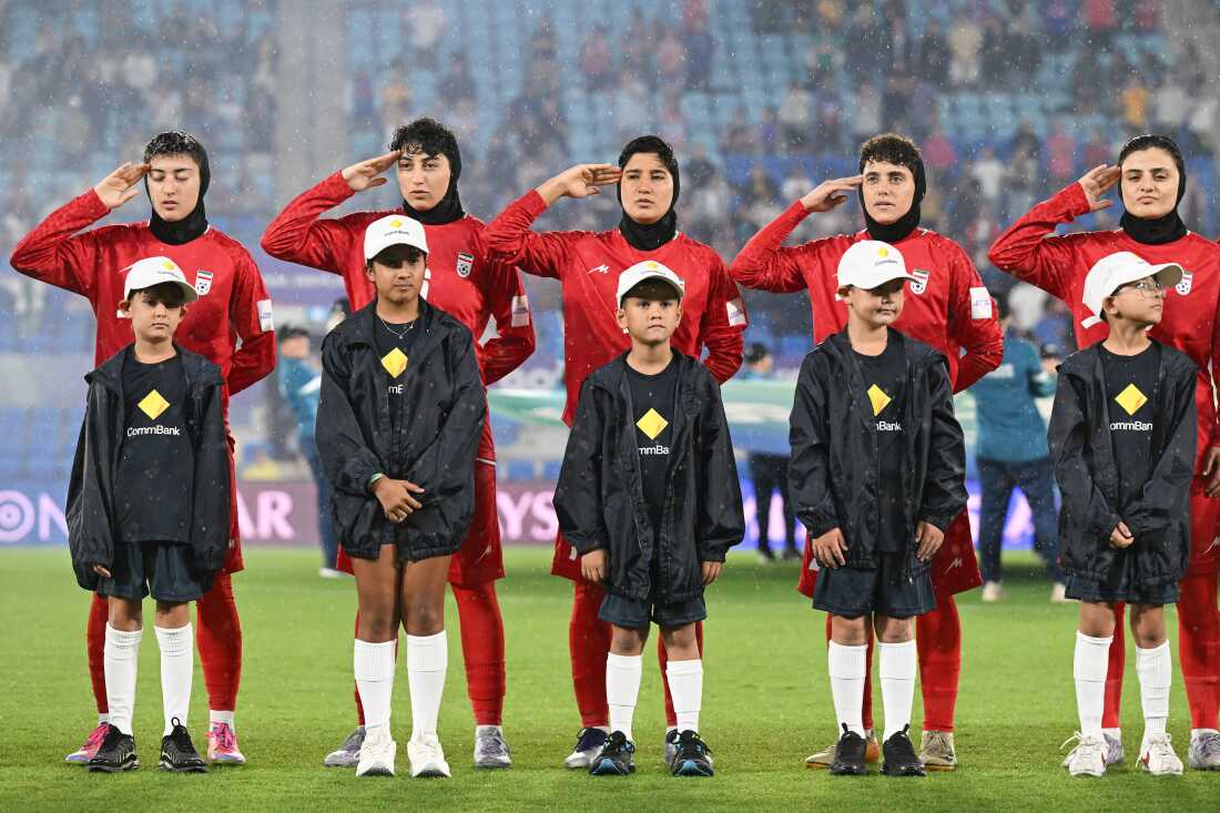 FILE - Iran players react during their national anthem ahead of the Women's Asian Cup soccer match between Iran and the Philippines in Robina, Australia, Sunday, March 8, 2026