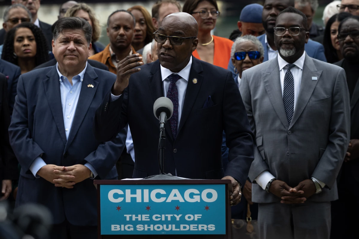 Flanked by Illinois Gov. JB Pritzker (L), Chicago Mayor Brandon Johnson and other Illinois politicians and community leaders, Illinois Attorney General Kwame Raoul speaks at a news conference to address President Donald Trump's plan to send National Guard troops into the city on August 25, 2025 in Chicago, Illinois.