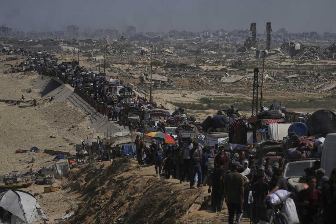 Displaced Palestinians flee northern Gaza along the coastal road toward the south, after Israel's military says its expanded operation in Gaza City has begun and warns residents to leave, Tuesday