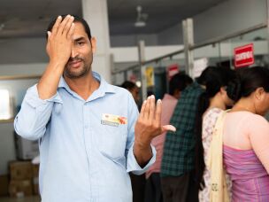 Mantu Das takes a vision test at the Rangia Post office.<br>