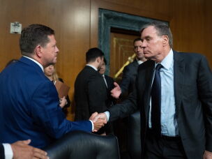 Jay Clayton, left, shakes hands with Sen. Mark Warner, D-Va., following his confirmation hearing for Director of National Intelligence on July 15, 2026. Warner says administration officials have failed to provide legally mandated pre-election reports to Congress on foreign election meddling efforts.