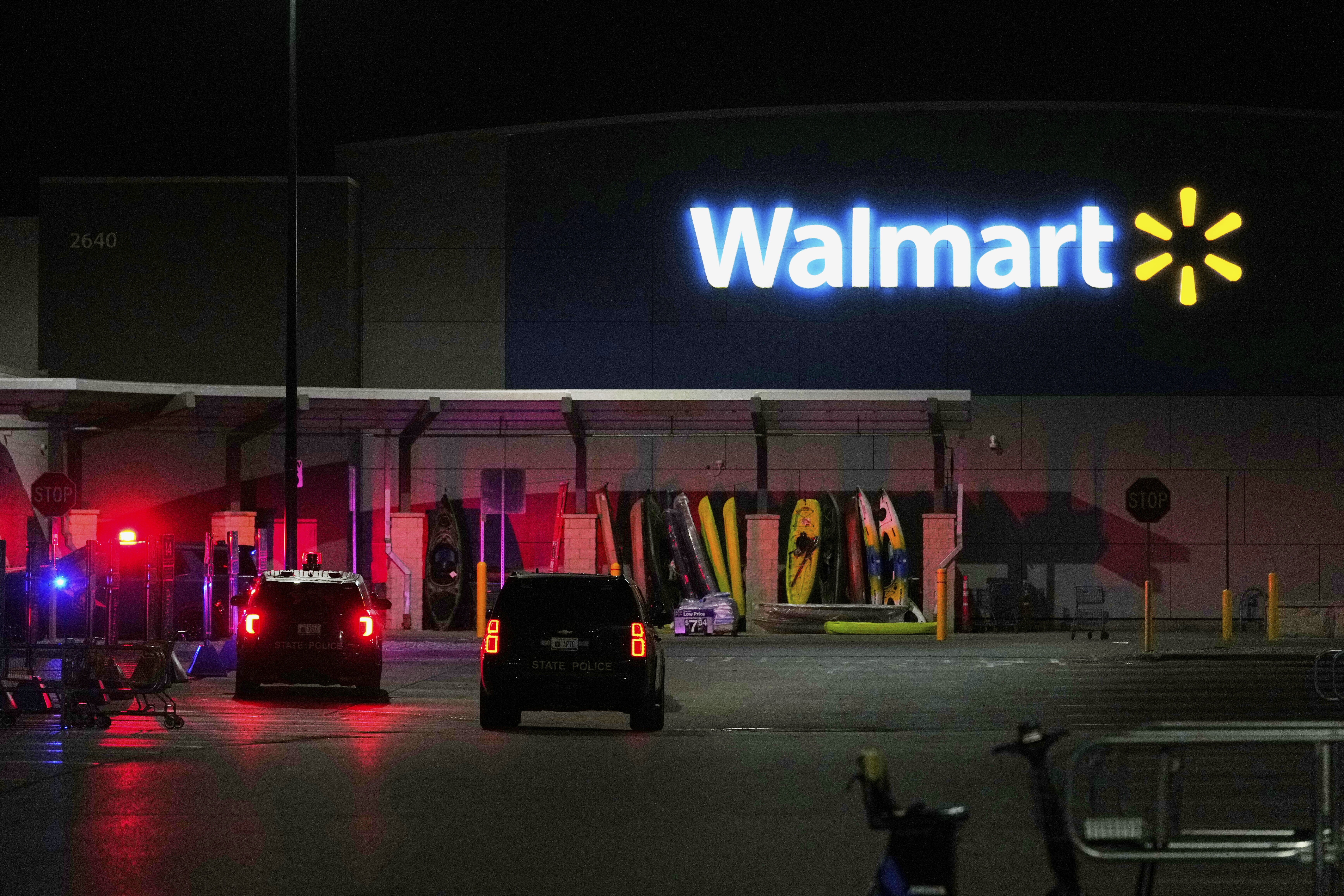 Law enforcement officers are seen stationed outside a Walmart where 11 people were stabbed in a violent attack Saturday, July 26, 2025, in Traverse City, Mich.