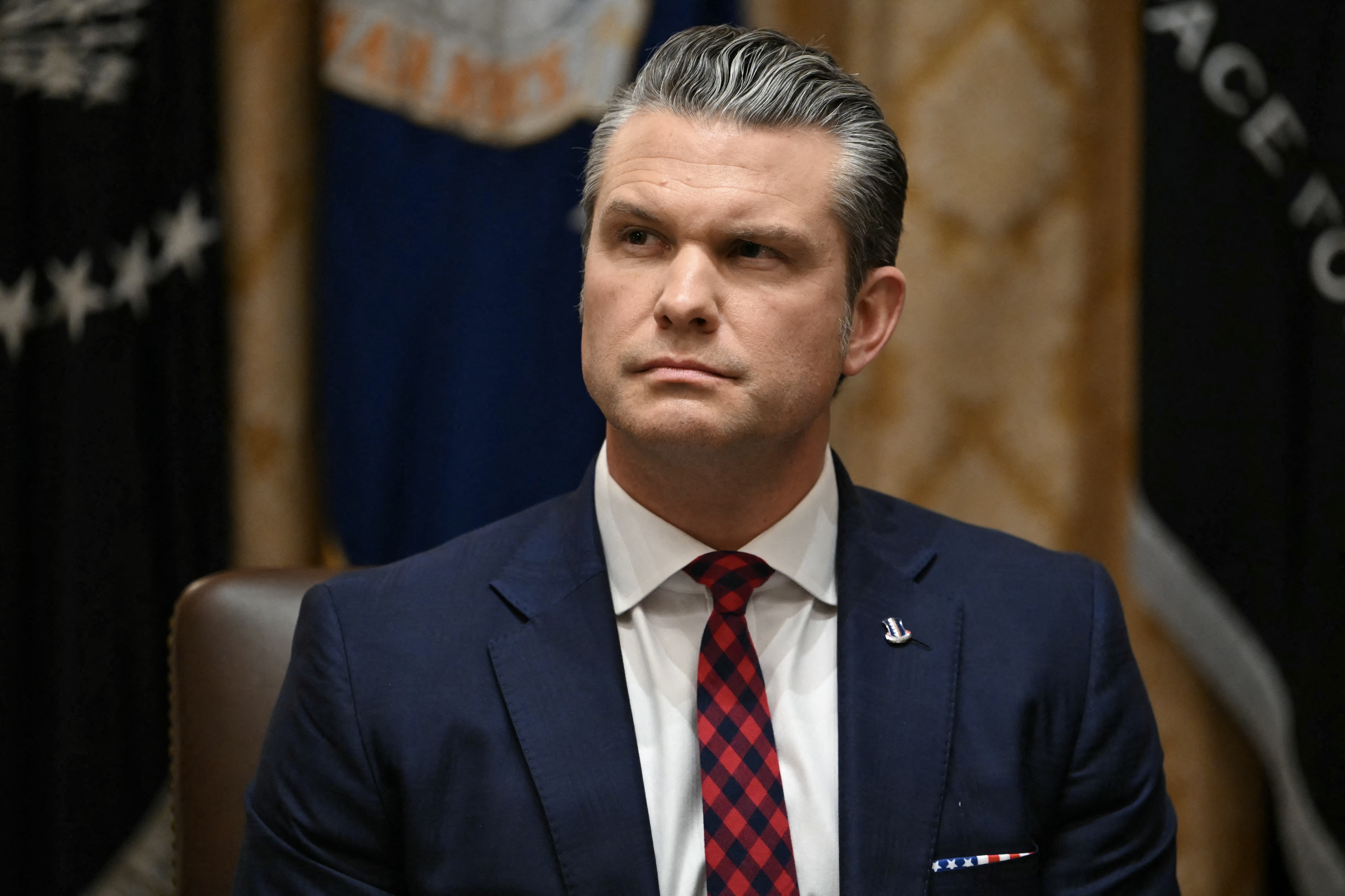 Secretary of Defense Pete Hegseth listens as President Donald Trump speaks during a Cabinet Meeting at the White House on Dec. 2. (AFP via Getty Images)