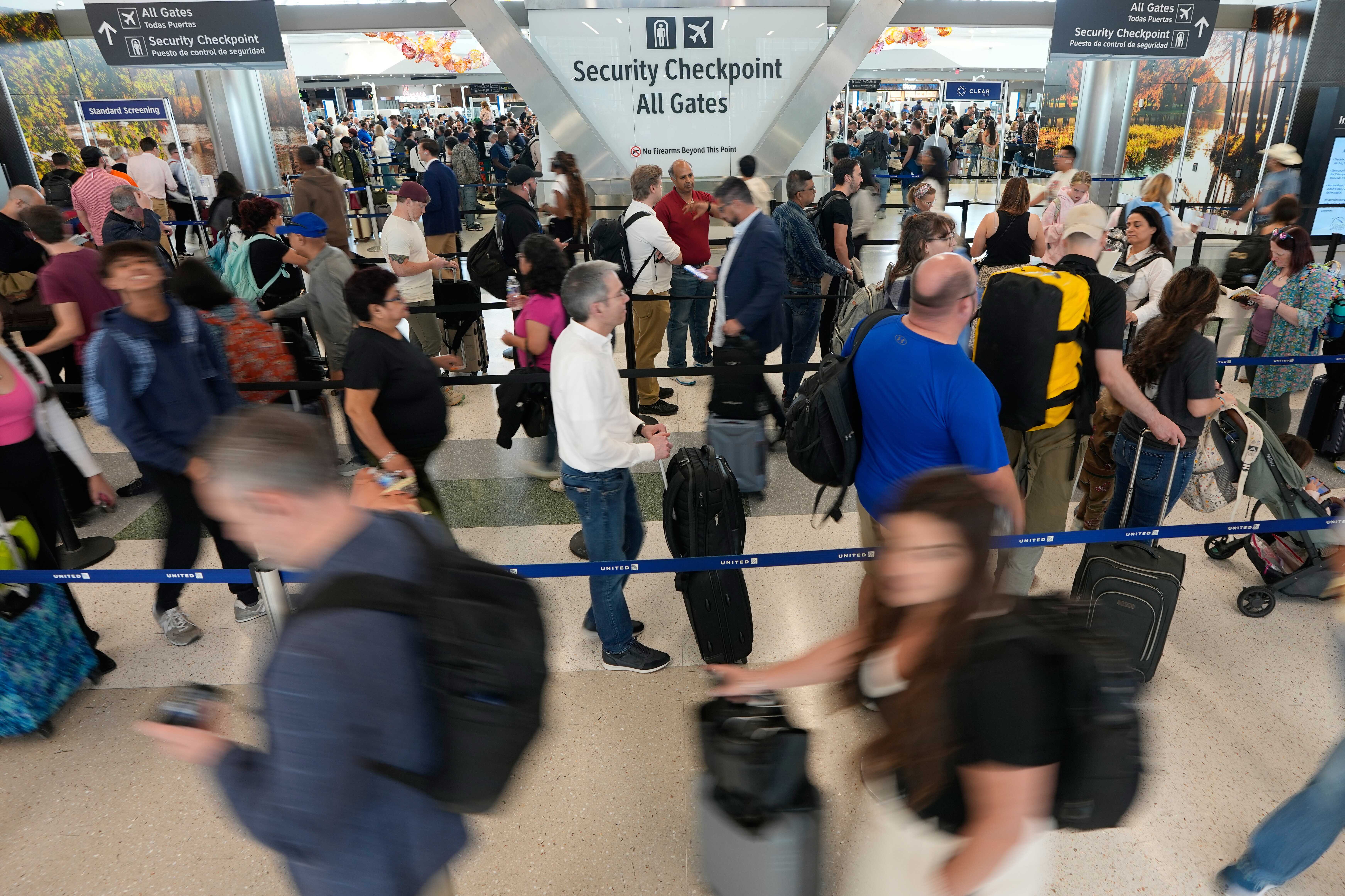 Travelers wait in long security checkpoint lines at George Bush Intercontinental Airport Friday, March 27, 2026, in Houston. (AP)