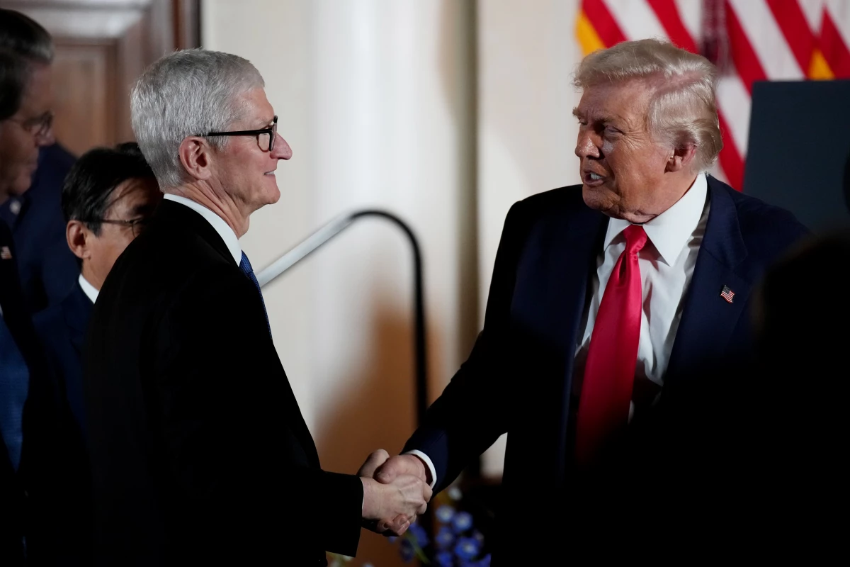 President Trump shakes hands with Apple CEO Tim Cook during a meeting with business leaders in Tokyo in October. Cook is among the CEOs who have personally courted Trump in the past year and whose companies' products have escaped the worst of Trump's tariffs.