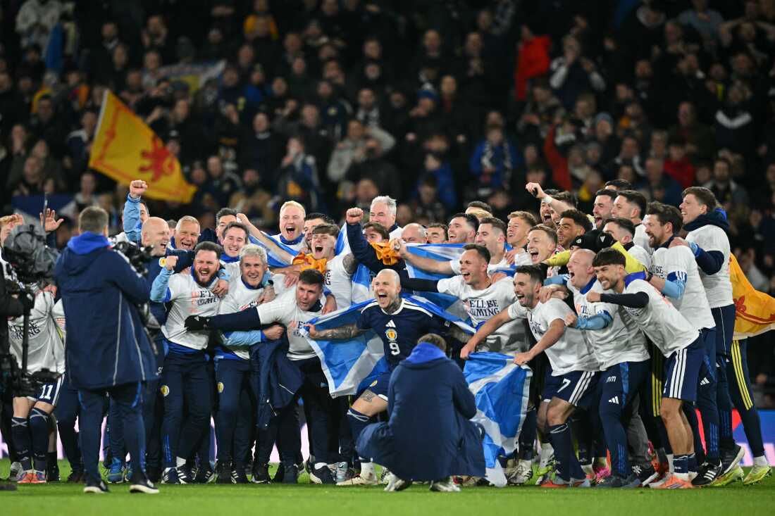 Scotland players celebrate on the pitch after the FIFA World Cup 2026 European qualification football match between Scotland and Denmark at Hampden Park in Glasgow on November 18, 2025.