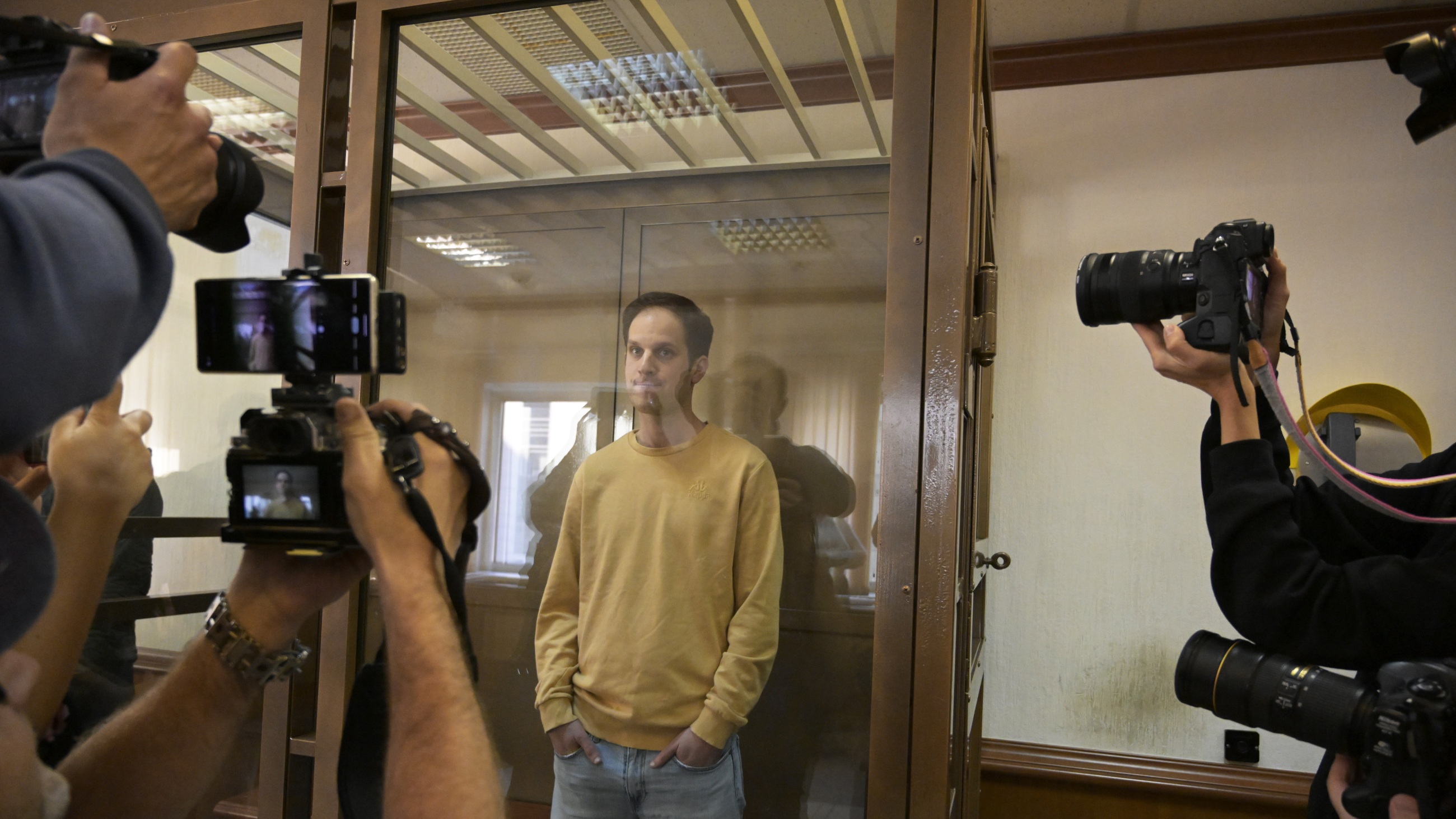 Wall Street Journal reporter Evan Gershkovich stands in the glass defendant's booth at the Moscow City Court, in Moscow on Sept. 19, 2023.