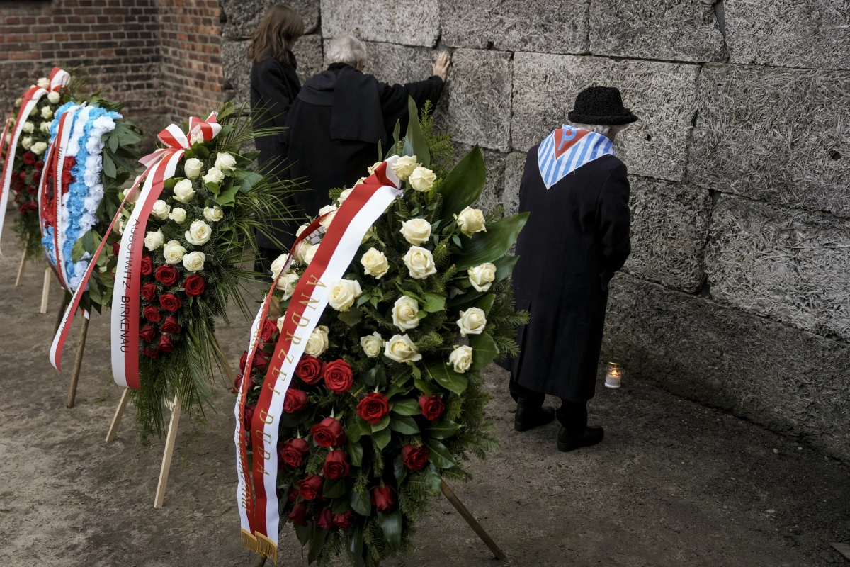 Survivors and relatives attend a ceremony at the Auschwitz-Birkenau former Nazi German concentration and extermination camp, in Oswiecim, Poland, on Monday.