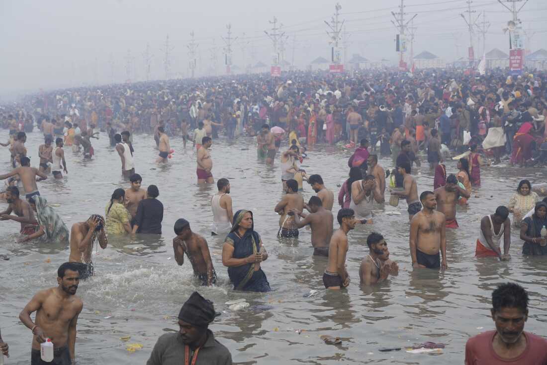 Hindu devotees take a holy dip by the banks of the Sangam, the confluence of the Ganges, the Yamuna and the mythical Saraswati rivers, on "Mauni Amavasya" or new moon day during the Maha Kumbh festival in Prayagraj, Uttar Pradesh, India on Wednesday.