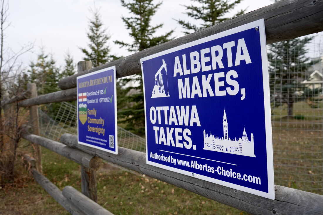 Political signs are posted on a property's fence in Wainwright, Alberta, Canada, Monday, Oct. 19, 2026.