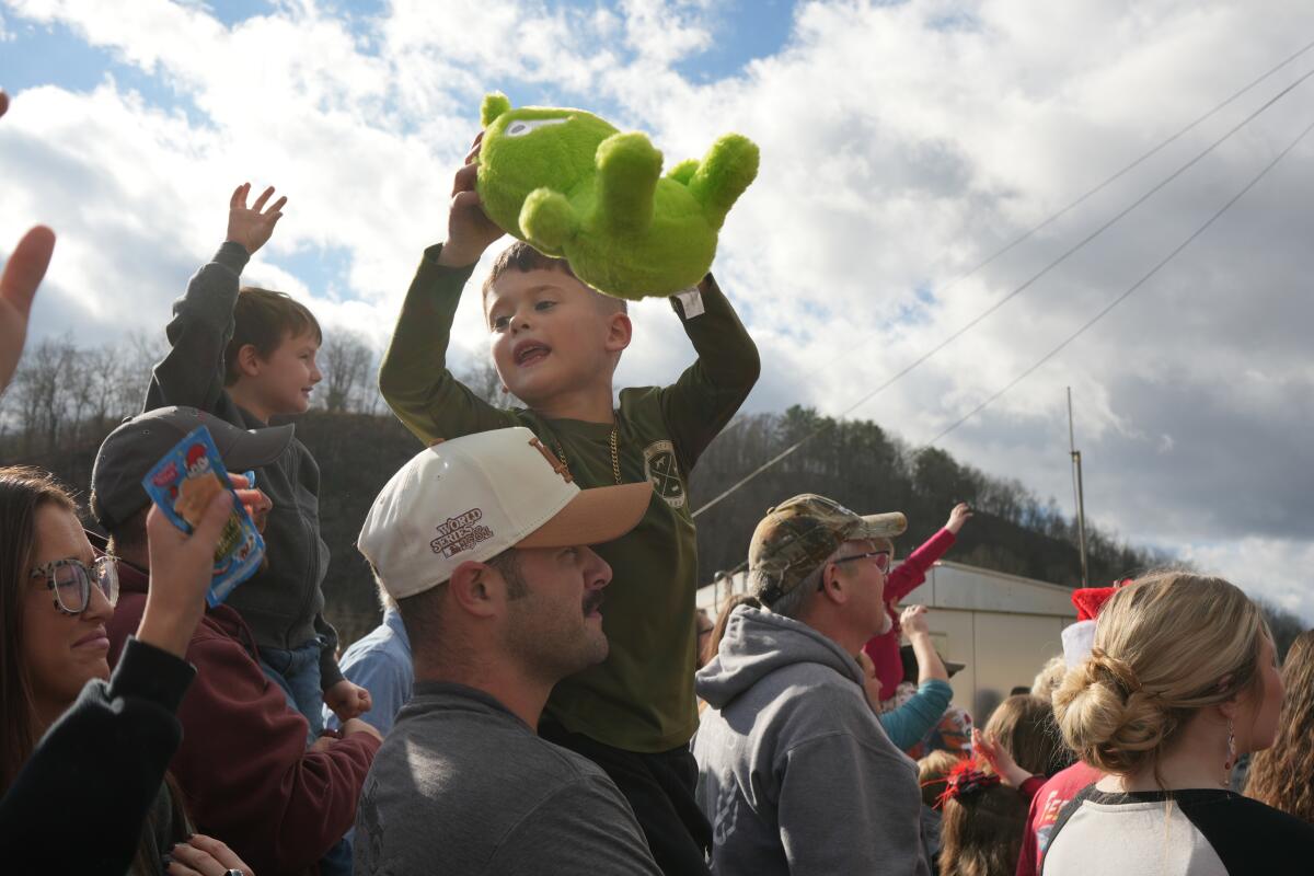 A child catches a plush toy from Santa Claus in St. Paul, Virginia, during the annual CSX Santa Train on Nov. 22, 2025.