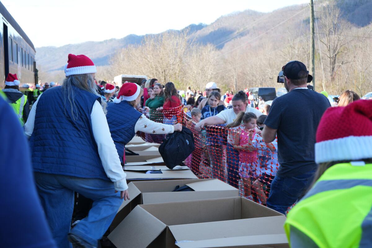Volunteers hand out backpacks to families in Kermit, Virginia, during the annual CSX Santa Train on Nov. 22, 2025.