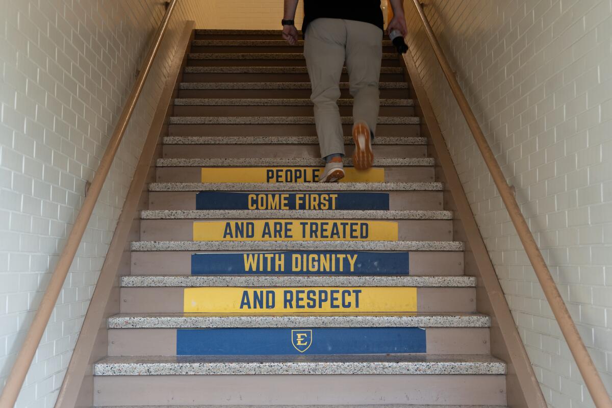 A stairwell in the northwest side of Rogers-Stout Hall on the campus of East Tennessee State University as seen on Wednesday, Nov. 19, 2025 bears a slogan reading, 'people come first and are treated with dignity and respect.'