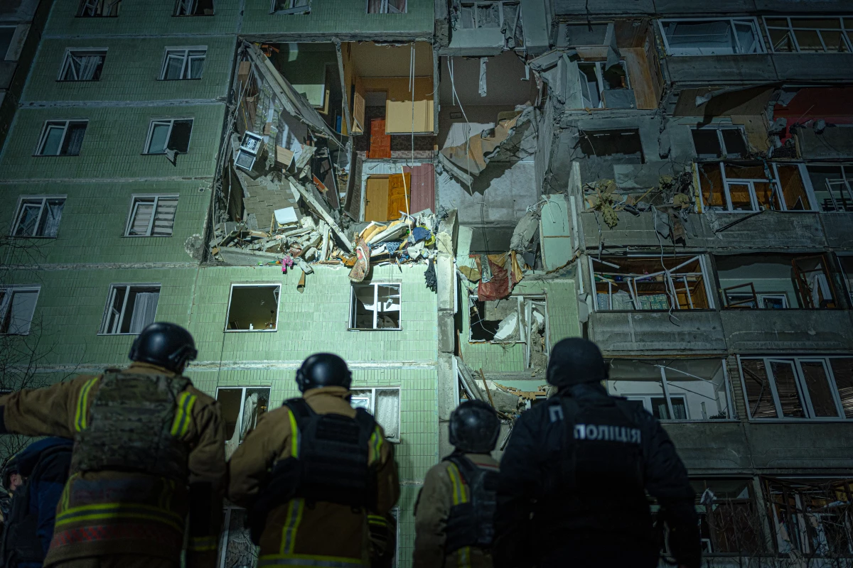 A rescue team gathers in front of a damaged residential building in Sumy just after a Russian drone strike that destroyed nine apartments and killed 11 people, Jan. 30.