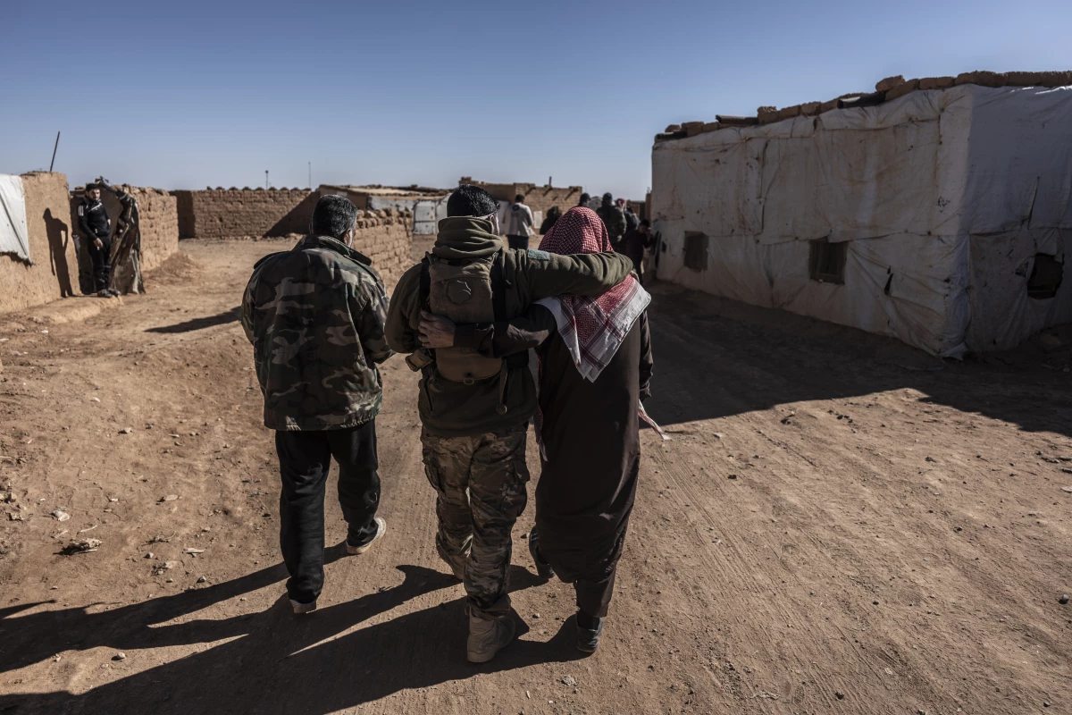 Syrians in the Rukban camp for displaced people, including members of the U.S.-backed Syrian Free Army, walk along a road in the camp, on Dec. 14.