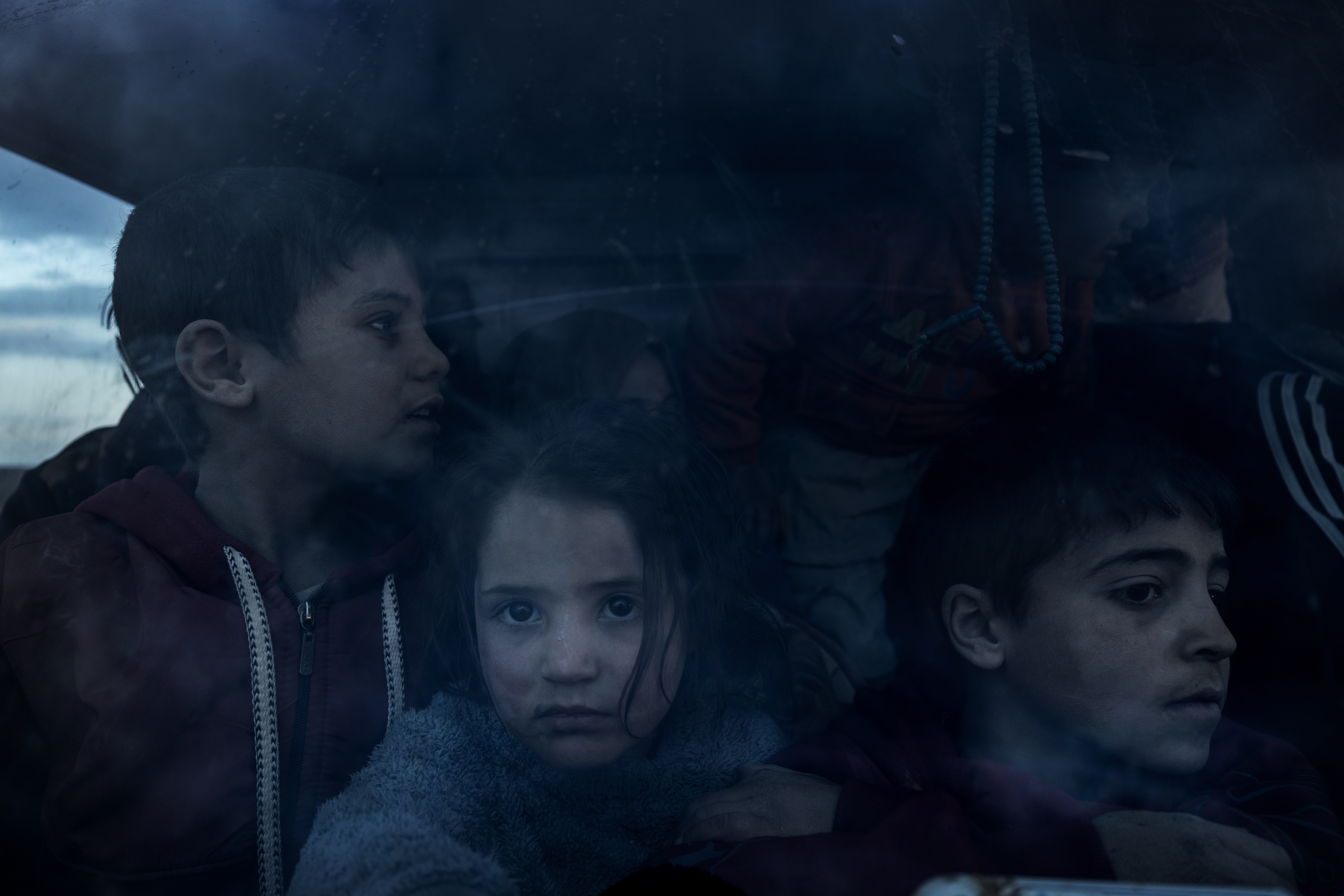 A group of Syrian children with their parents return home in the cabin of a truck, after more than eight years taking shelter in the Rukban camp for displaced people in al-Tanf, Syria, at the edge of the Jordanian border, Dec. 14.