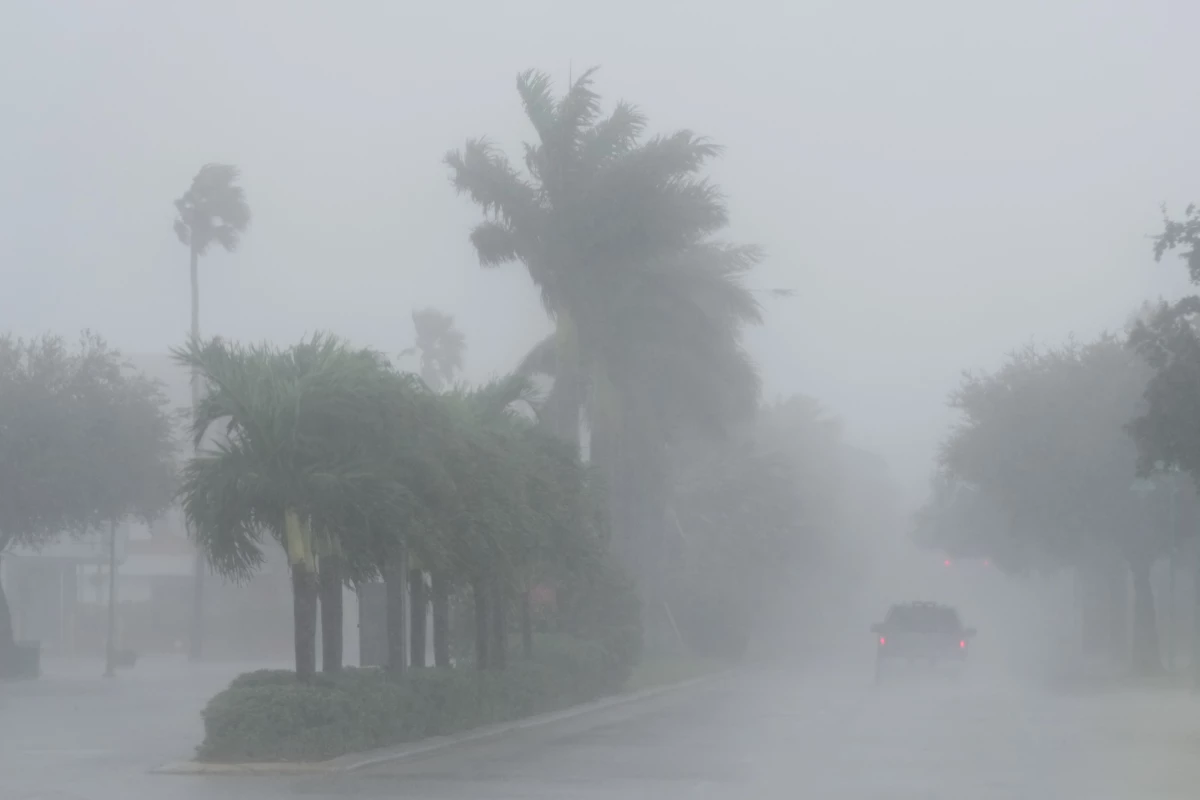 A Lee County Sheriff's officer patrols the streets of Cape Coral, Fla., as heavy rain falls ahead of Hurricane Milton on Wednesday.