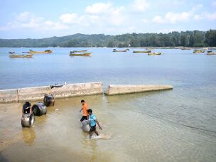 Great Nicobar Islanders clean vessels near Campbell Bay.