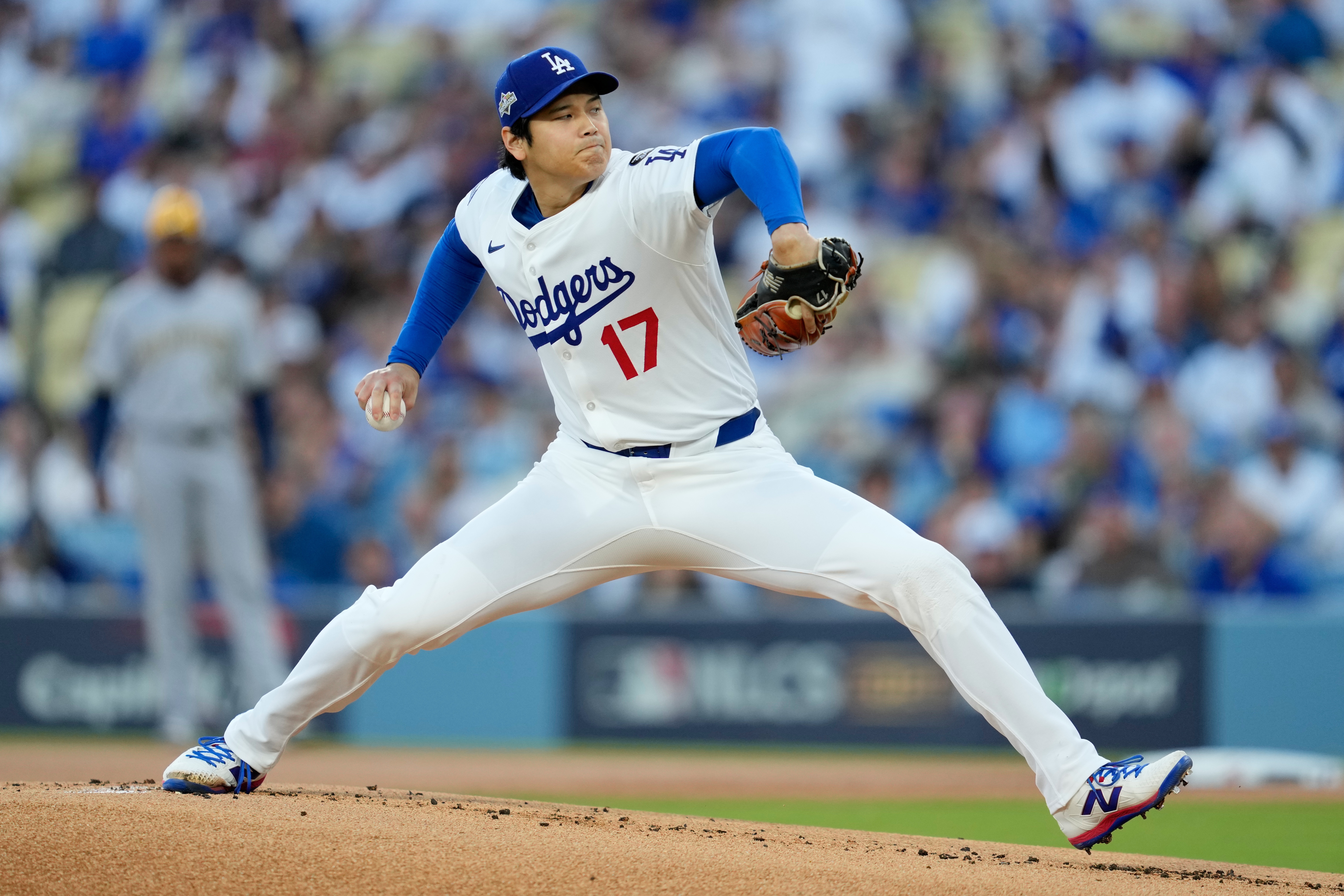 Los Angeles Dodgers pitcher Shohei Ohtani throws against the Milwaukee Brewers during the first inning in Game 4 of baseball