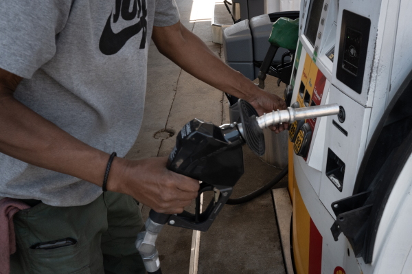 A customer purchases gas in June at a station in Chicago, Illinois.