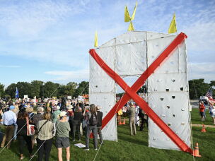 Protesters stand Thursday in Memorial Circle near a mockup of Trump's arch, which they say would be 32 times taller.