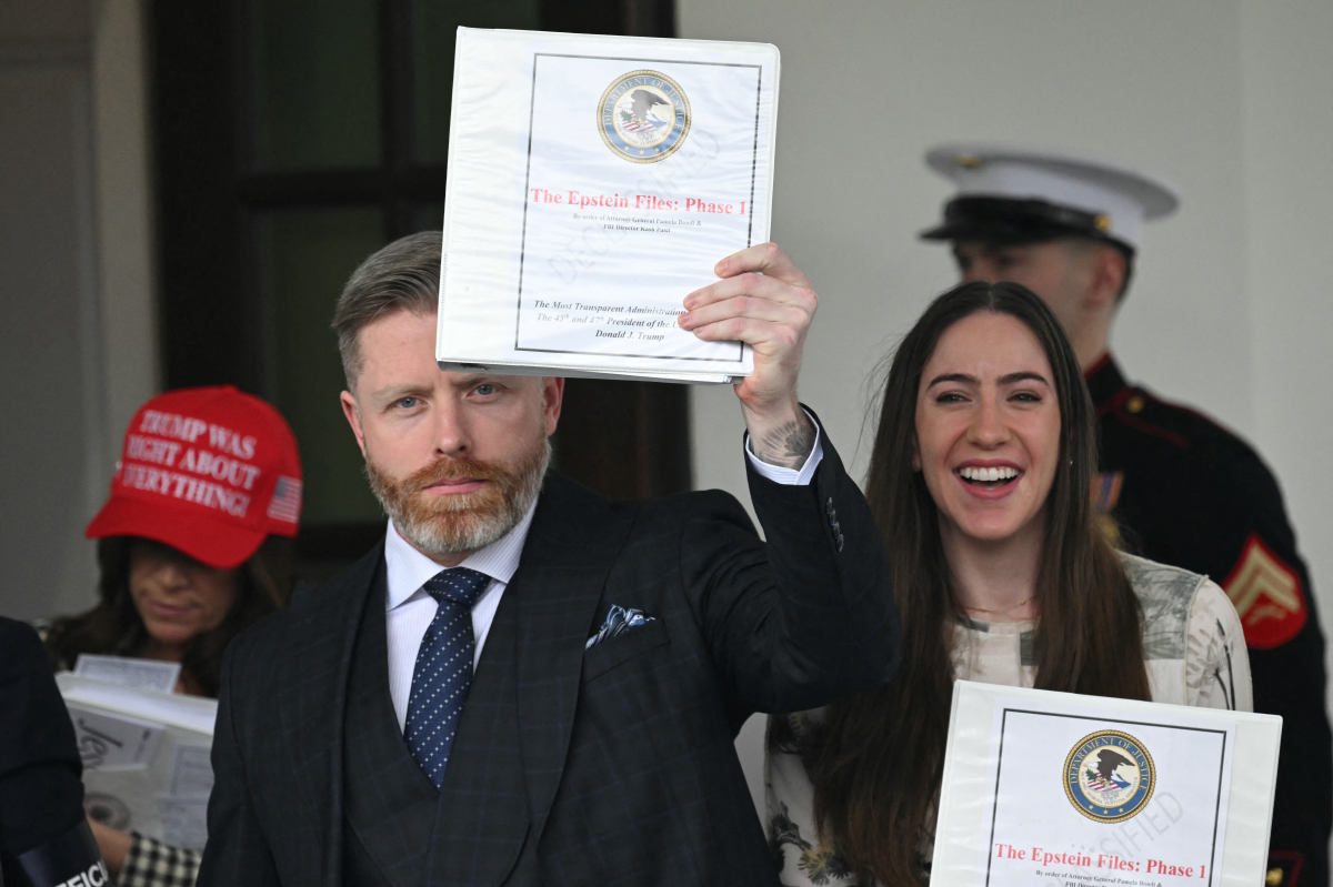Political influencer Rogan O'Handley, known online as DC Draino, center, next to influencers Jessica Reed Kraus on the left and Chaya Raichik, right, carry binders bearing the seal of the U.S. Justice Department reading 'The Epstein Files: Phase 1' as they walk out of the the White House in February 2025. The administration mostly released old materials to the influencers, leading to disappointment and strains within Trump's coalition.