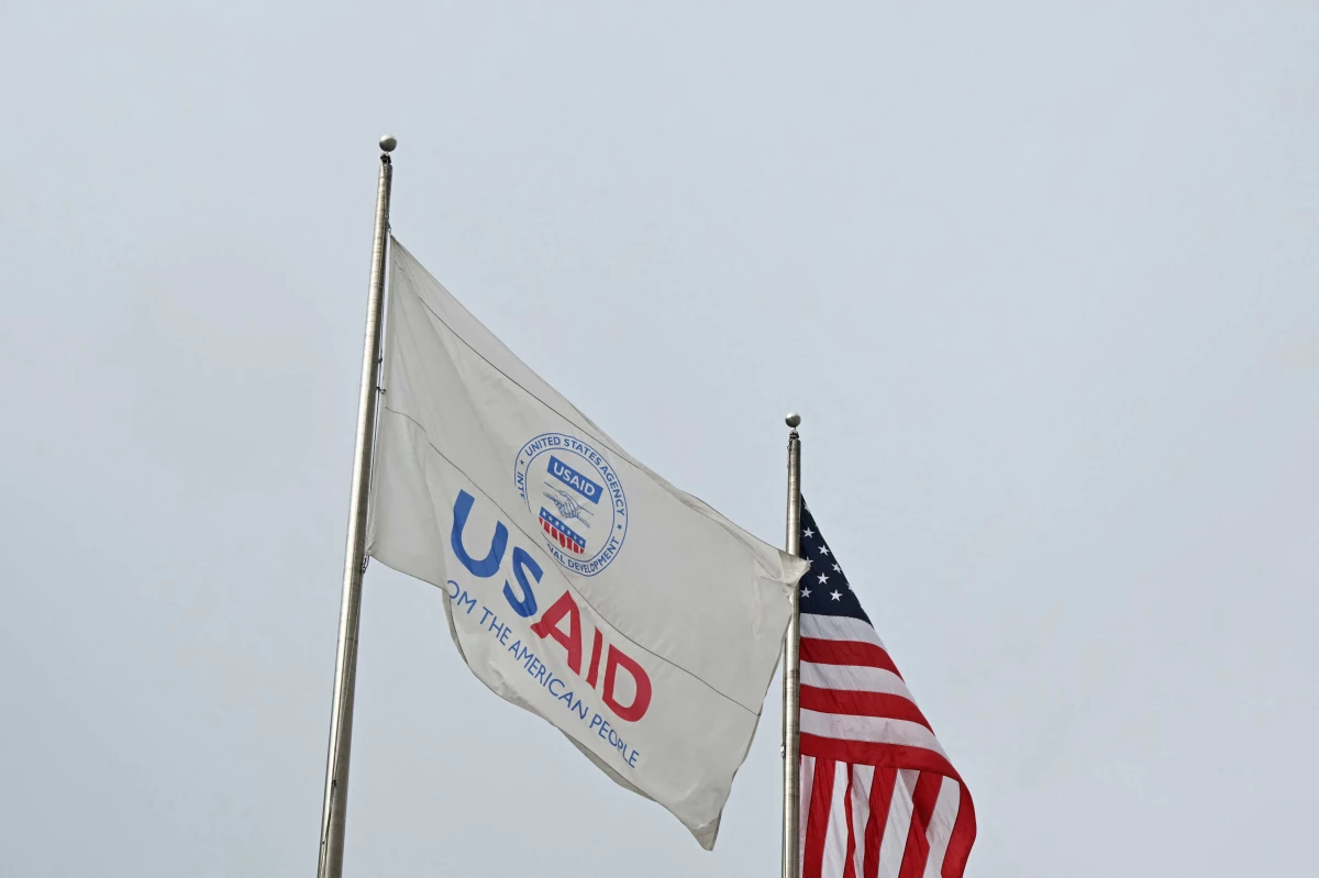 A USAID and American flag outside of United States Agency for International Development (USAID) headquarters in Washington, DC, on Feb. 3, 2025.