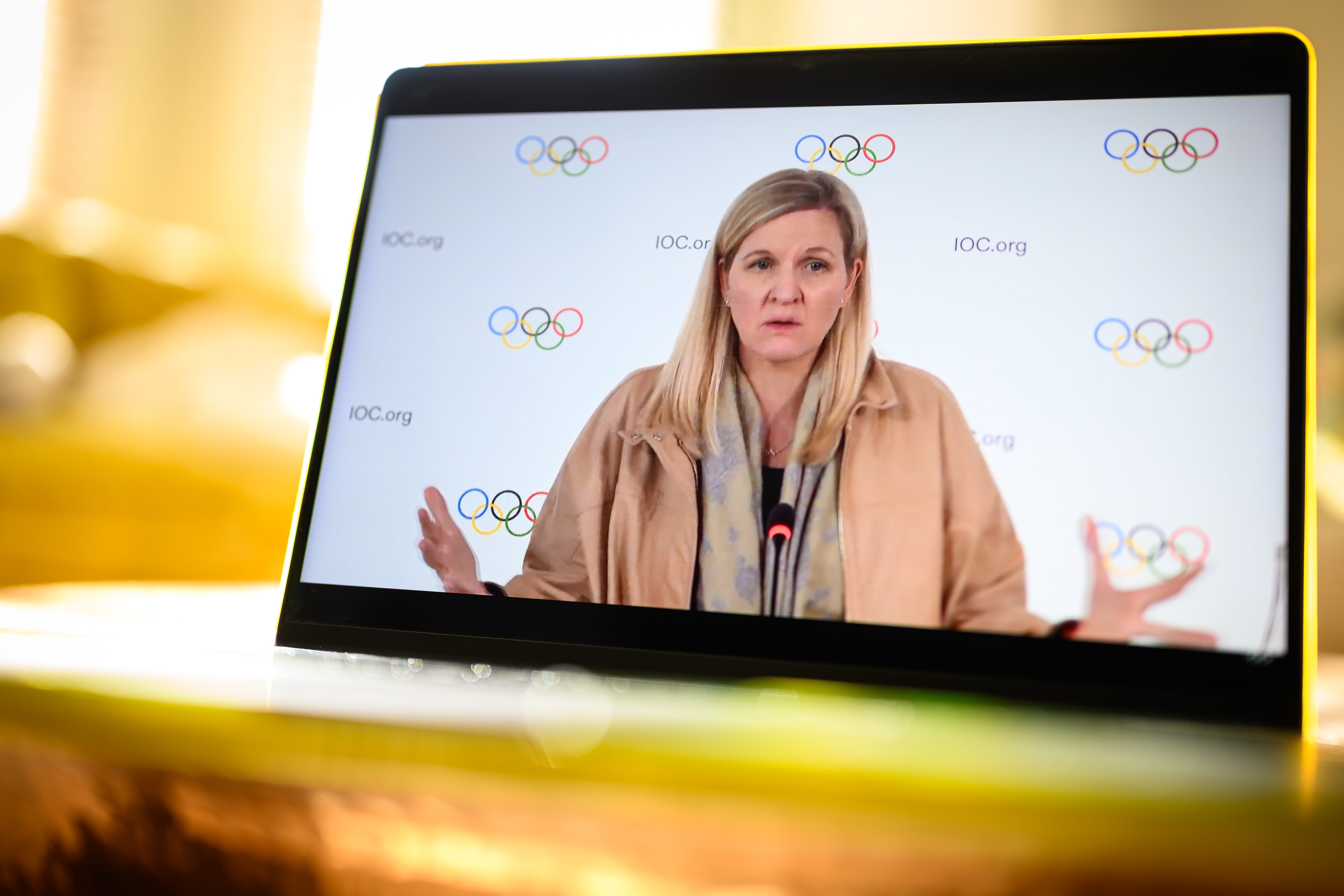 IOC President Kirsty Coventry is shown on a computer screen as she speaks at a live-streamed press briefing Thursday from Lausanne, Switzerland, about the ban on transgender athletes in women