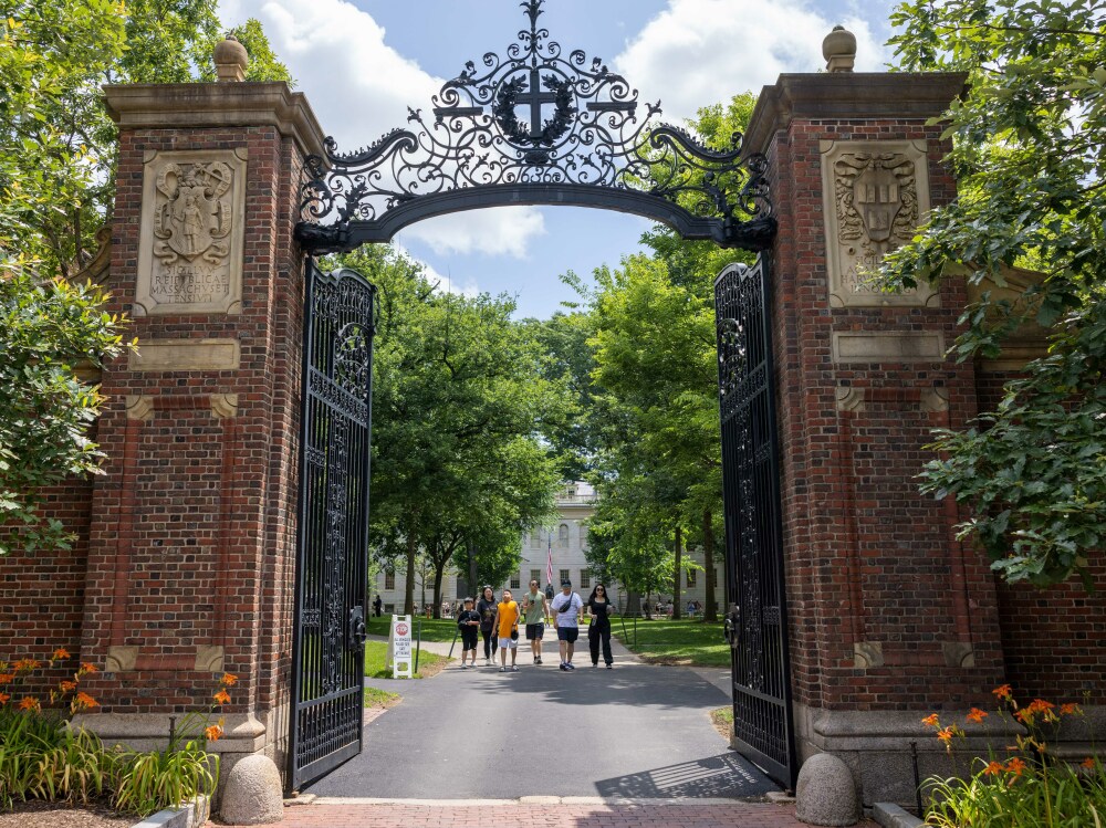 People walk through the gate on Harvard Yard at the Harvard University campus in Cambridge, Mass. (Getty Images)