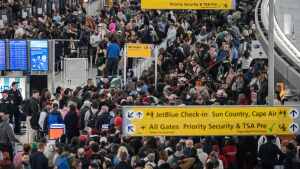People wait in a TSA line at the John F. Kennedy International Airport on Sunday in New York City.