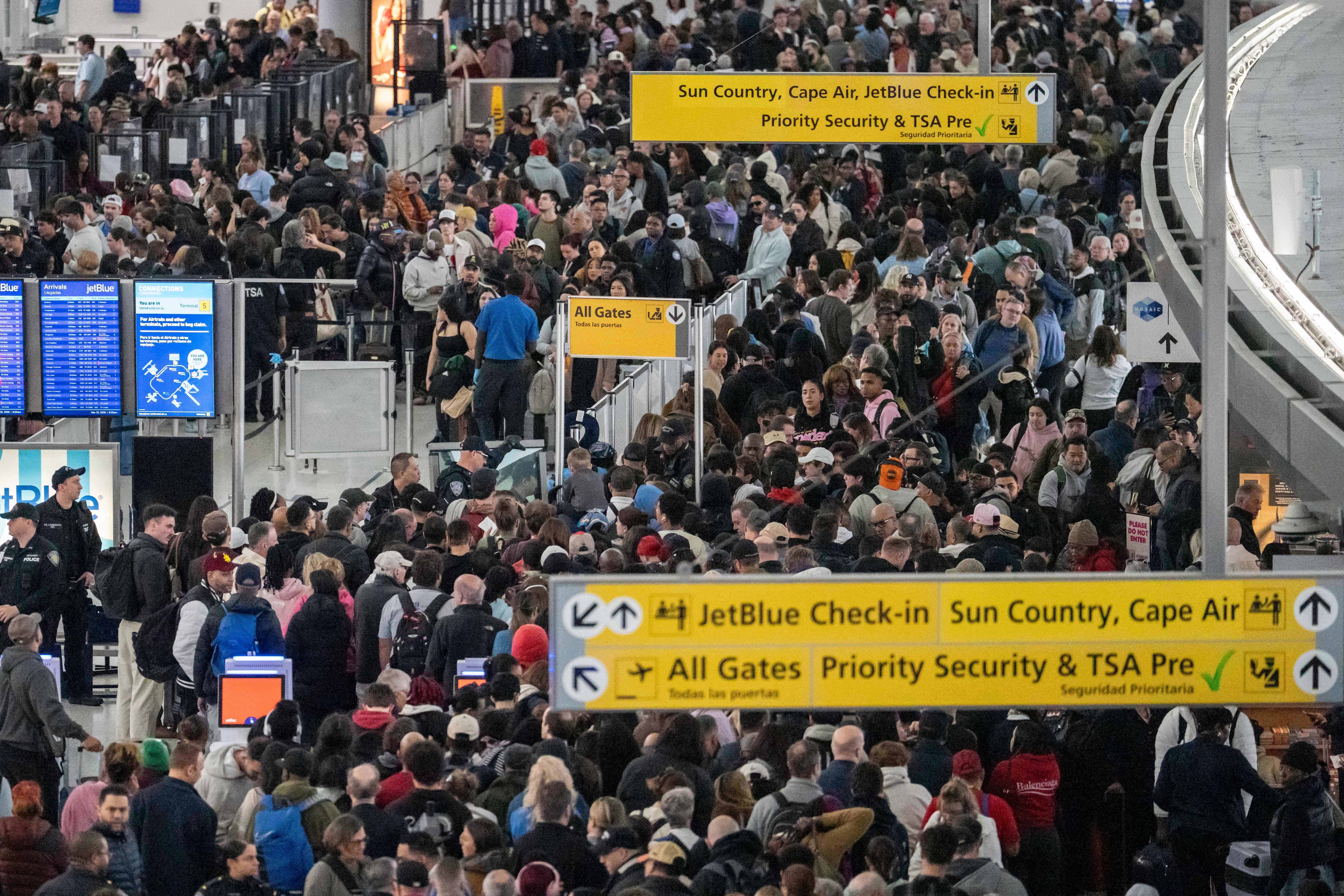 People wait in a TSA line at the John F. Kennedy International Airport on Sunday in New York City. (AP)