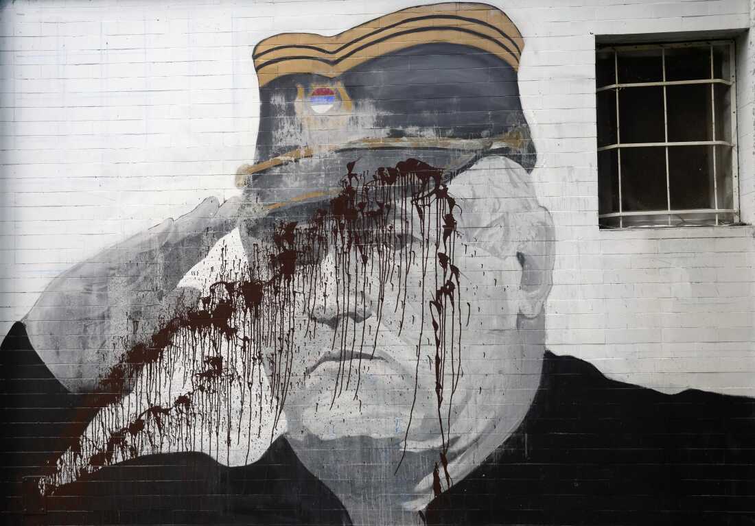 A mural of former Bosnian Serb military chief Ratko Mladic vandalized with paint in Belgrade, Serbia, Sept. 20, 2022.