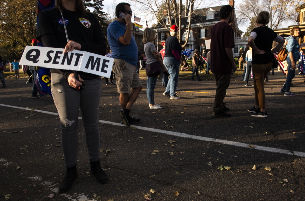 A woman holds a sign referencing the QAnon conspiracy on Nov. 7, 2020, in St. Paul, Minn.