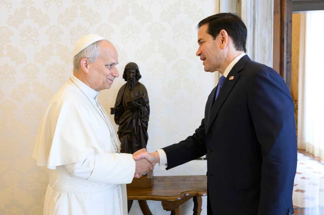 Pope Leo XIV greets U.S. Secretary of State Marco Rubio, right, upon his arrival for talks in the pope's private library at the Vatican.