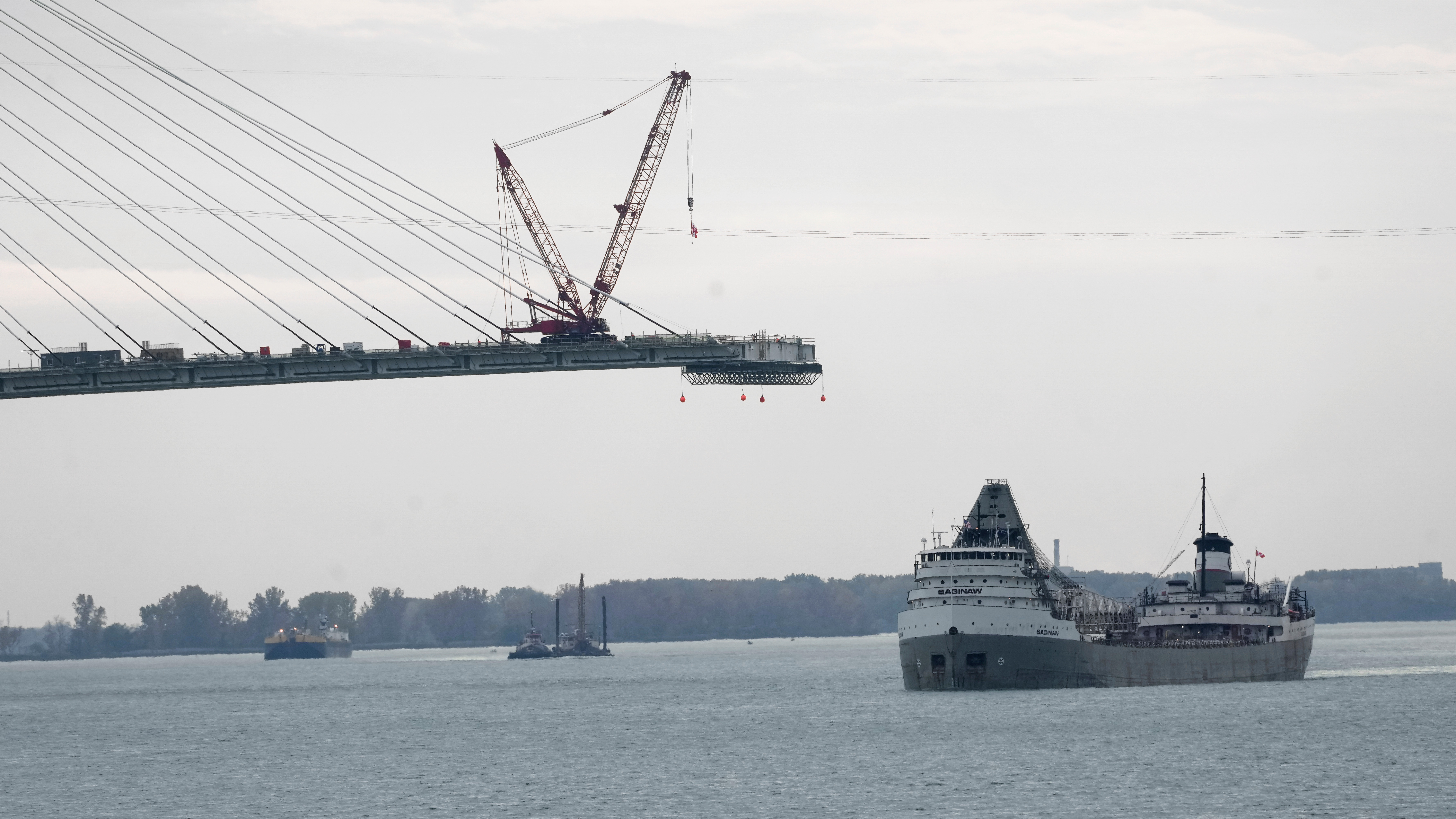 FILE - The Saginaw passes construction on the Gordie Howe International Bridge connecting on the Detroit River connecting Windsor, Ontario and Detroit, Oct. 25, 2023.