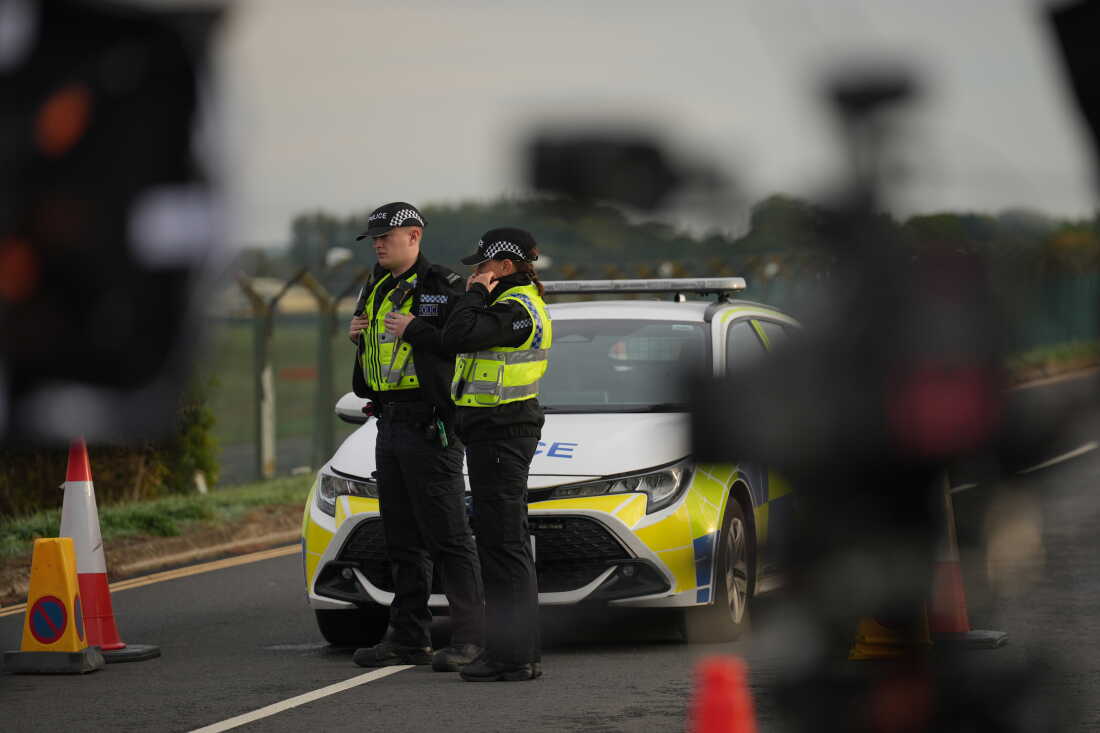 Police officers guard a road leading to RAF Fairford, after an incident in Fairford, England, Monday Sept. 28, 2026.