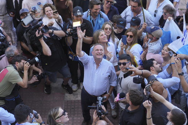 Alvaro Delgado, candidate for the ruling National Party, waves after voting in the presidential run-off election in Montevideo, Uruguay on Sunday.