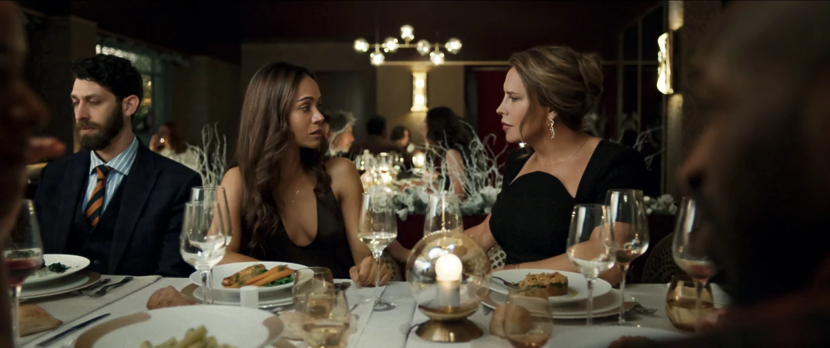 Zoe Saldaña's character Rita Moro Castro (left) meets her one-time client for the first time as Emilia Pérez (right).