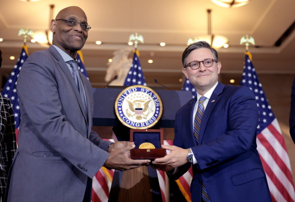 House Speaker Mike Johnson (right) presents the Congressional Gold Medal for the 6888th Central Postal Directory Battalion to Stanley Earley III, the son of battalion commander Maj. Charity Adams, during a ceremony in Emancipation Hall on Tuesday in Washington, D.C.