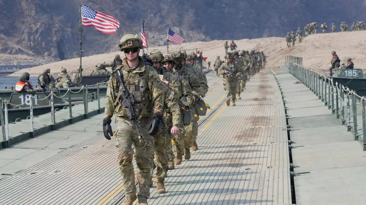 FILE - U.S. Army soldiers cross a floating bridge on the Imjin River during a joint river-crossing exercise between South Korea and the United States as a part of the Freedom Shield military exercise in Yeoncheon, South Korea, March 20, 2025.