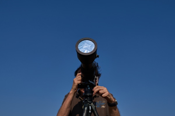 Javier Sanchez, a member of the "Los Taraos" astrophotography group, sets up his photo camera to shoot a total solar eclipse in Berlanga de Duero, central Spain.
