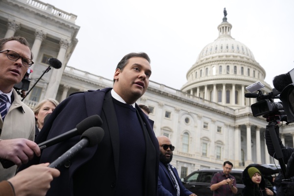 George Santos is surrounded by journalists as he leaves the U.S. Capitol after his fellow members of Congress voted to expel him from the House of Representatives on December 01, 2023. The New York Republican was later sentenced to prison on a range of federal charges, b