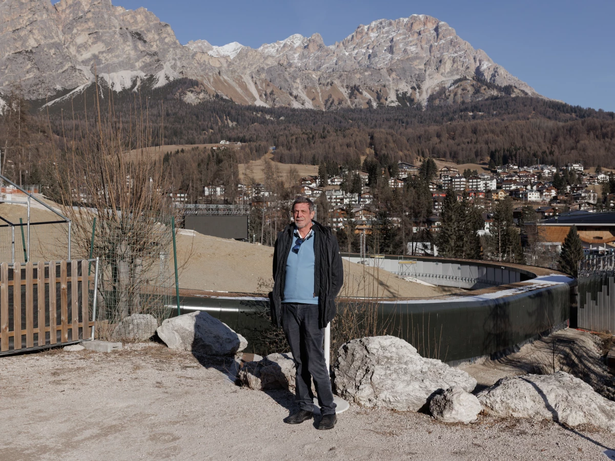Luigi Casanova, director of the local environmental group Mountain Wilderness, stands before the construction site of the new bobsled track. He and other activists have criticized the project for the broader environmental impact on the Dolomite Mountains, which are a UNESCO World Heritage site.