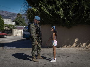 A Lebanese girl speaks with a Spanish UNIFIL soldier as he patrols the streets of the Christian village of Ibel al-Saqi. Since September 2006, the Spanish Armed Forces have been deployed in Lebanon. Over the years, the Spanish contingent has carried out numerous civil-military cooperation (CIMIC) activities aimed at strengthening ties with local communities.