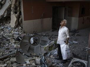 Najib Ayyad checks has returned to his destroyed home in Nabatiyeh, Lebanon, to salvage what remains for his children.
