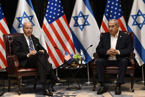 US President Joe Biden (L) listens to Israel's Prime Minister Benjamin Netanyahu as he joins a meeting of the Israeli war cabinet in Tel Aviv on October 18 amid the ongoing battles between Israel and the Palestinian group Hamas. US President Joe Biden landed in Tel Aviv on October 18, 2023 as Middle East anger flared after hundreds were killed when a rocket struck a hospital in war-torn Gaza, with Israel and the Palestinians quick to trade blame. (Photo by Brendan SMIALOWSKI / AFP) (Photo by BRENDAN SMIALOWSKI/AFP via Getty Images)