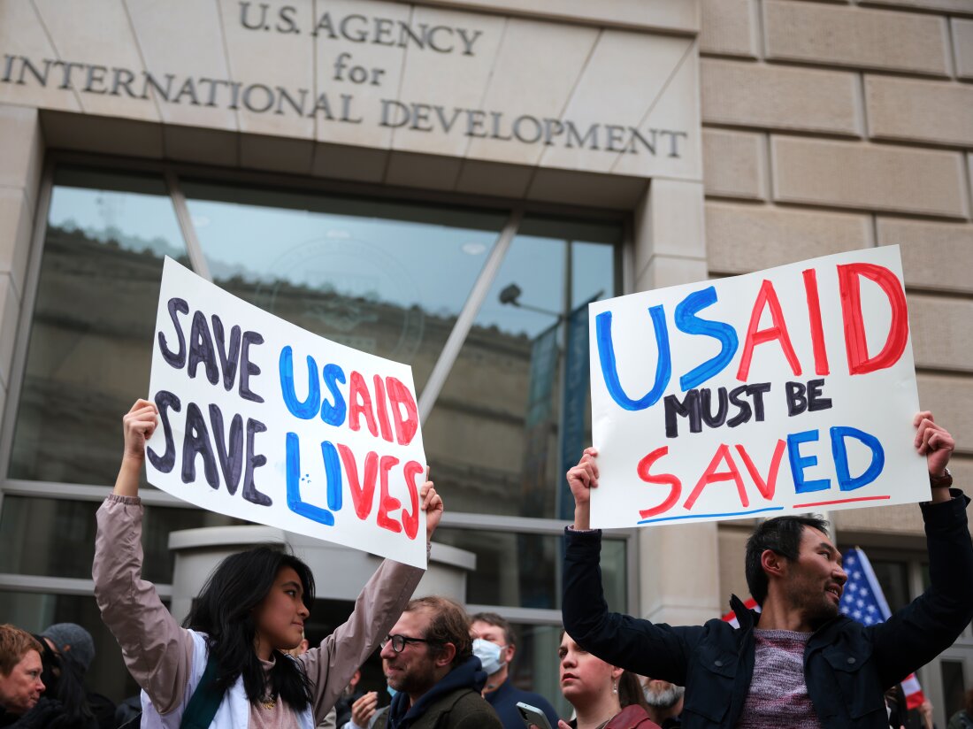 Protesters gather outside of USAID headquarters in Washington, D.C., on Monday, after Elon Musk said his Department of Government Efficiency will shut down the foreign assistance agency.